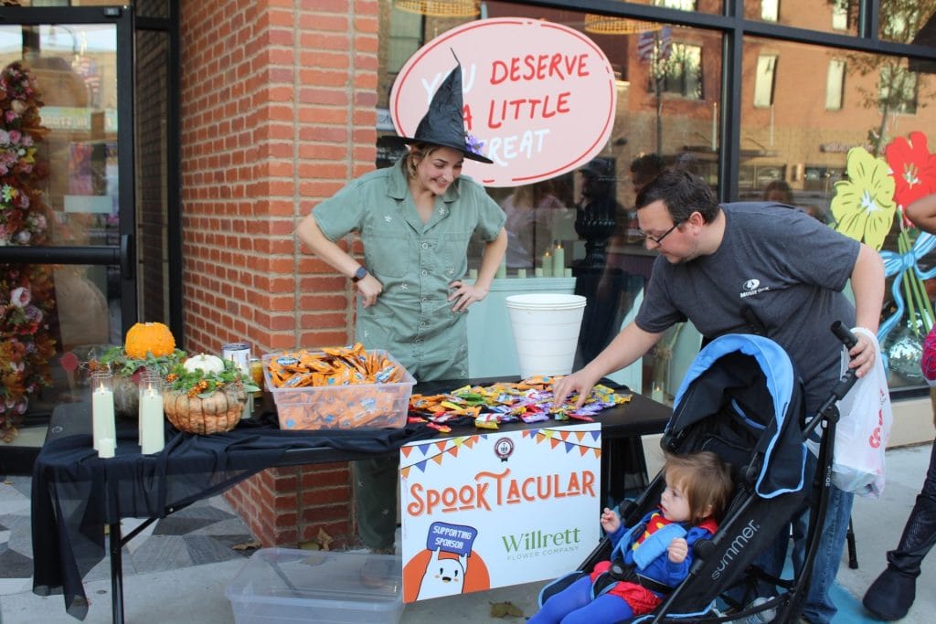 Family grabs candy during Downtown DeKalb trick-or-treating