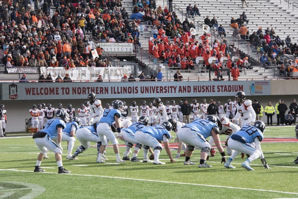 football players kickoff at Huskie Stadium