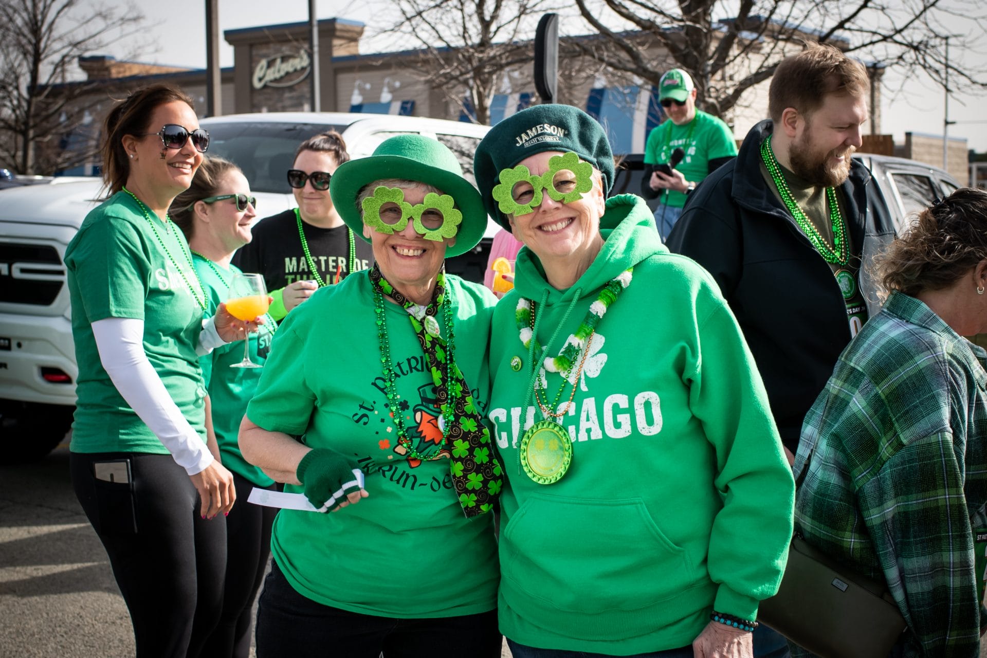 2 women pose with St. Patrick's Day outfits on